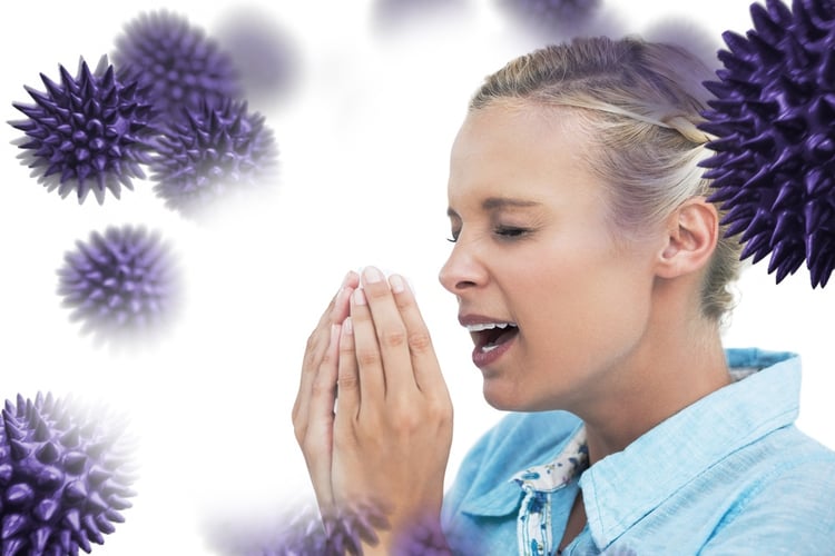 Blonde woman sneezing with hands in front of her face against virus.jpeg